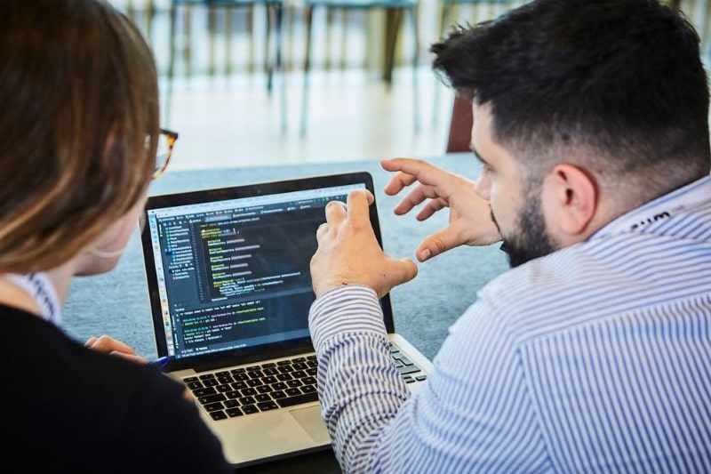 Instructors and students collaborating on Python coding exercises and case studies.