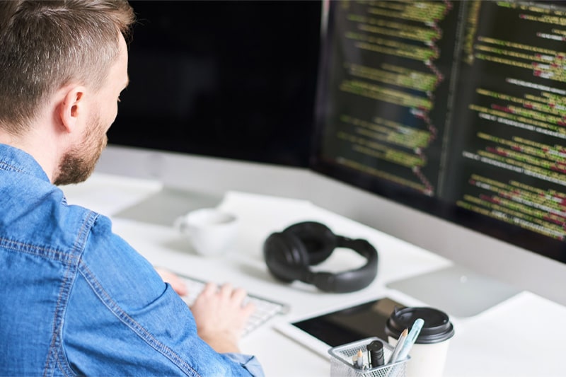 Man coding in Python, illustrating career paths and IT skill enhancement training.