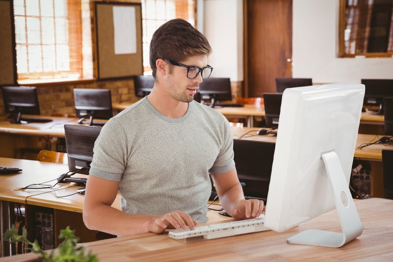 Man coding on computer illustrating Java training and career opportunities.