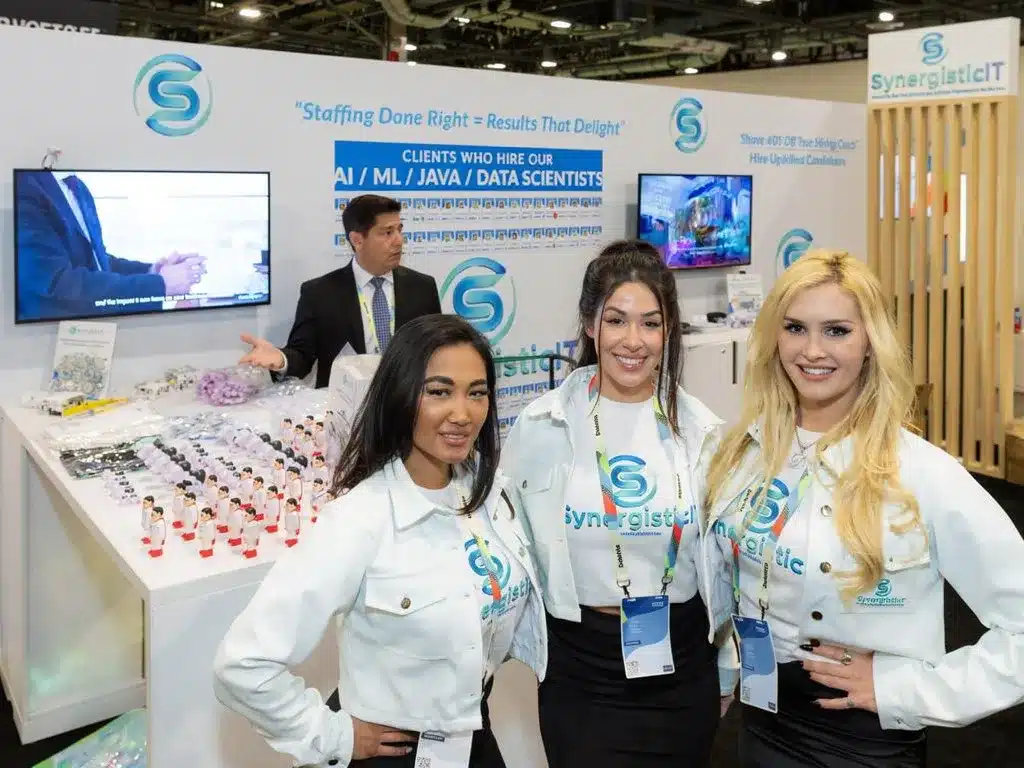 SynergisticIT staffing booth at conference, showcasing AI, ML, Java, and data scientists, with staff and