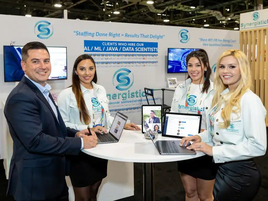 SynergisticIT staffing booth at conference, showcasing IT talent and Java/Data Science expertise.
